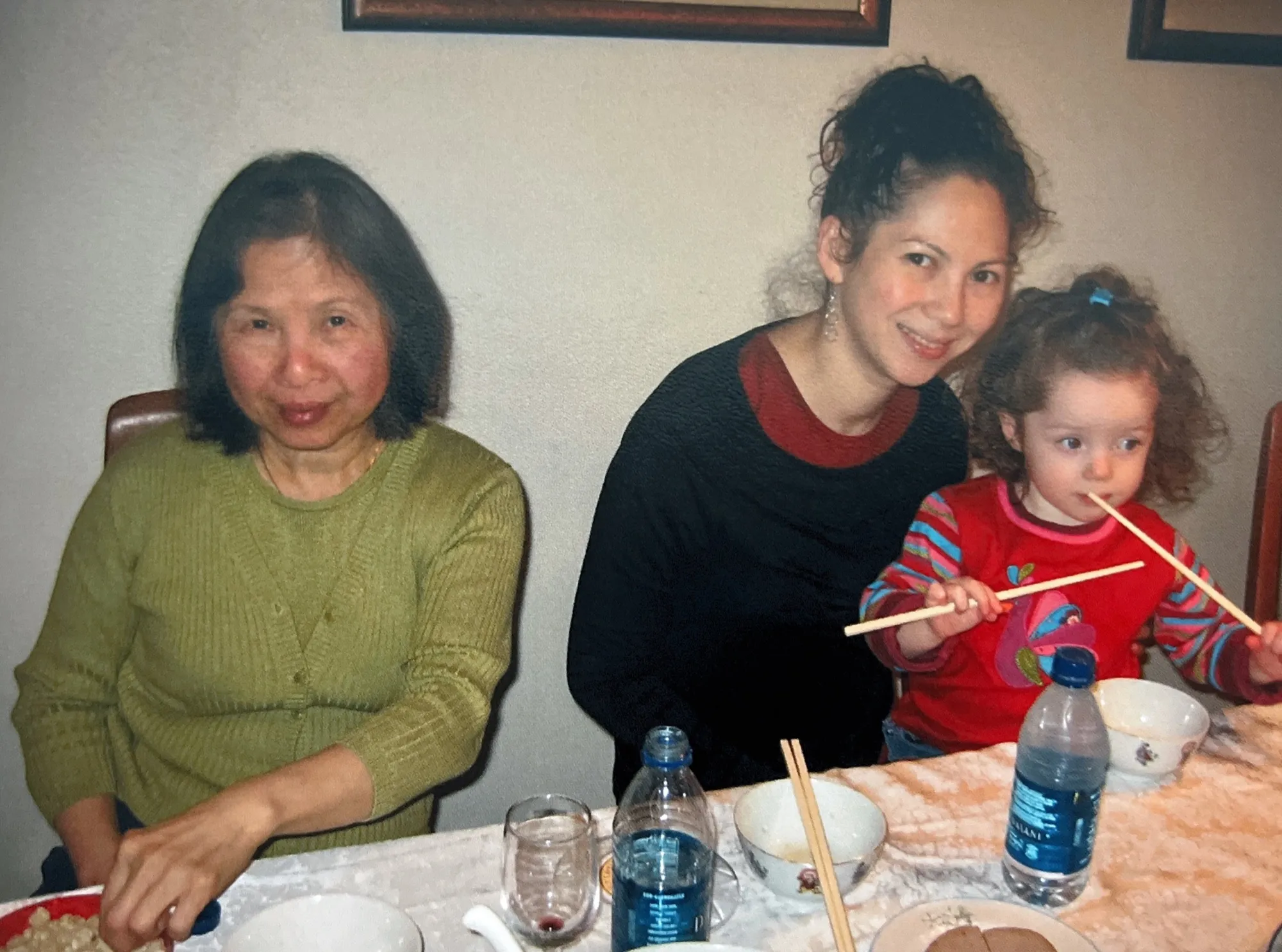 Cassia as a toddler, eating with chopsticks